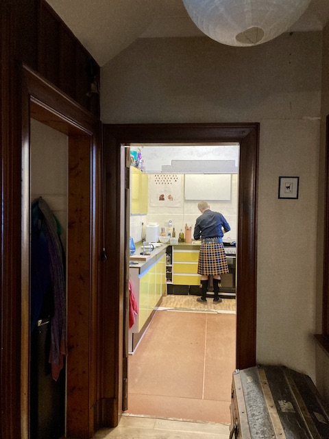 キッチンで料理している男性の後ろ姿